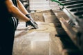Young chef preparing kneading the dough for pizza or bread on the table in restaurant kitchen. Side view. Royalty Free Stock Photo