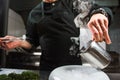 Young chef preparing modern molecular dish with liquid nitrogen