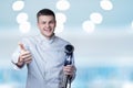 A chef shows with his hand well and holds a device for cooking with a low temperature in his hand Royalty Free Stock Photo