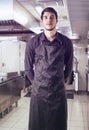 Young chef or waiter wearing black apron isolated Royalty Free Stock Photo