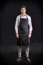Young chef or waiter wearing black apron Royalty Free Stock Photo