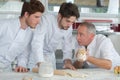 Young chefs preparing food in kitchen at restaurant