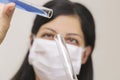 Young chemical female researcher holding in laboratory