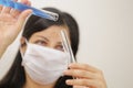 Young chemical female researcher holding in laboratory