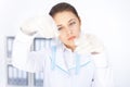 Young chemical female researcher holding two glass tubes