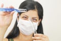 Young chemical female researcher holding two glass tubes