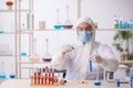 Young male chemist in drugs syntesis concept Royalty Free Stock Photo