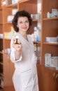 Young chemist showing bottle of pills Royalty Free Stock Photo