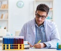 Young chemist student working in lab on chemicals Royalty Free Stock Photo