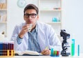 Young chemist student working in lab on chemicals Royalty Free Stock Photo