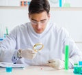 Young chemist student working in lab on chemicals Royalty Free Stock Photo