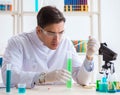 Young chemist student working in lab on chemicals Royalty Free Stock Photo