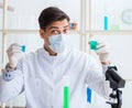 Young chemist student working in lab on chemicals Royalty Free Stock Photo