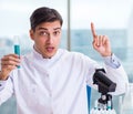 Young chemist student working in lab on chemicals Royalty Free Stock Photo