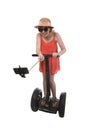 Young chic tourist woman taking selfie photo with mobile phone while riding on segway