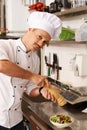 Young chief cook on kitchen in restaurant