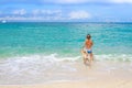 Young child boy having fun with white dog in the sea, summ Royalty Free Stock Photo