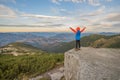 Young child boy hiker standing with raised hands in mountains enjoying view of amazing mountain landscape at sunset Royalty Free Stock Photo