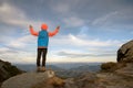 Young child boy hiker standing with raised hands in mountains enjoying view of amazing mountain landscape at sunset Royalty Free Stock Photo