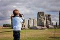 Young child, boy, taking pic with digital camera at Stonehenge Royalty Free Stock Photo