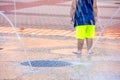 Young child in city splash pad