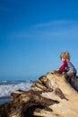 Young child climbing tree looking at ocean Royalty Free Stock Photo