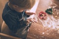 Young child cuts out cookies