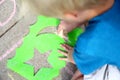 Young Child Drawing Outside with Sidewalk Chalk Royalty Free Stock Photo