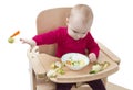 Young child eating in high chair Royalty Free Stock Photo