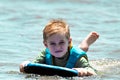 Young child enjoying body boarding on ocean waves Royalty Free Stock Photo