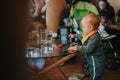Young Child Exploring and Playing at a Table Surrounded by a Casual Indoor Setting Royalty Free Stock Photo