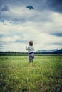 Young child flying a kite