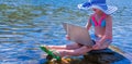 Young child girl having a video chat through laptop on the sea beach. Summer vacation and holiday concept, studying online with Royalty Free Stock Photo