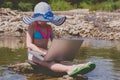 Young child girl learning remotely outdoors with laptop Summer vacation and holiday concept, studying online with tablet, distance Royalty Free Stock Photo