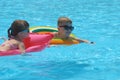 Young child girl relaxing on summer sun swimming on inflatable air mattress in swimming pool during tropical vacations Royalty Free Stock Photo