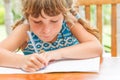 young child girl writing in notebook, outdoors portrait, education idea Royalty Free Stock Photo