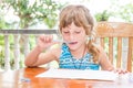 young child girl writing in notebook, outdoors portrait, education idea Royalty Free Stock Photo