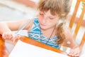 young child girl writing in notebook, outdoors portrait, education idea Royalty Free Stock Photo