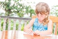 young child girl writing in notebook, outdoors portrait, education idea Royalty Free Stock Photo