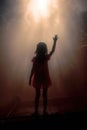 young child with her arm to the sky in seek of help. praising and praying concept. children and religion. Royalty Free Stock Photo