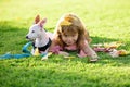 Young child and his dog lying on the grass. Happy boy kid and pet puppy on nature. Happiness support friendship summer Royalty Free Stock Photo