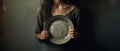 a young child holding a empty plate. helping the needy concept. poverty and hunger concept. beggar, begging. Royalty Free Stock Photo