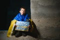 Young child, holding sign in support to peace, no war wanted, kid wishing peaceful life. Picture in connection with the