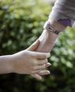 Young child holding a woman hand Royalty Free Stock Photo