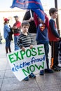 A Child Holds a Sign Reading `Expose Election Fraud Now` at a Stop the Steal Rally