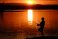 Young Child Kid Person Fishing in Lake or River Sunset Royalty Free Stock Photo