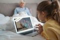 Young child learning about medicine online to help grandma recover