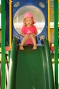 Young child looking sad on a playground slide Royalty Free Stock Photo