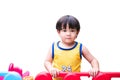 Young Child Playing on Colorful Playground. Asian toddler Boy in a yellow jersey enjoys playtime on a vibrant, colorful playground Royalty Free Stock Photo