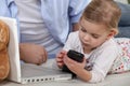 Child playing with mobile phone Royalty Free Stock Photo